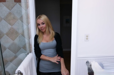Young stepmom helps stepson relax balls sucking big dick in the bathroom