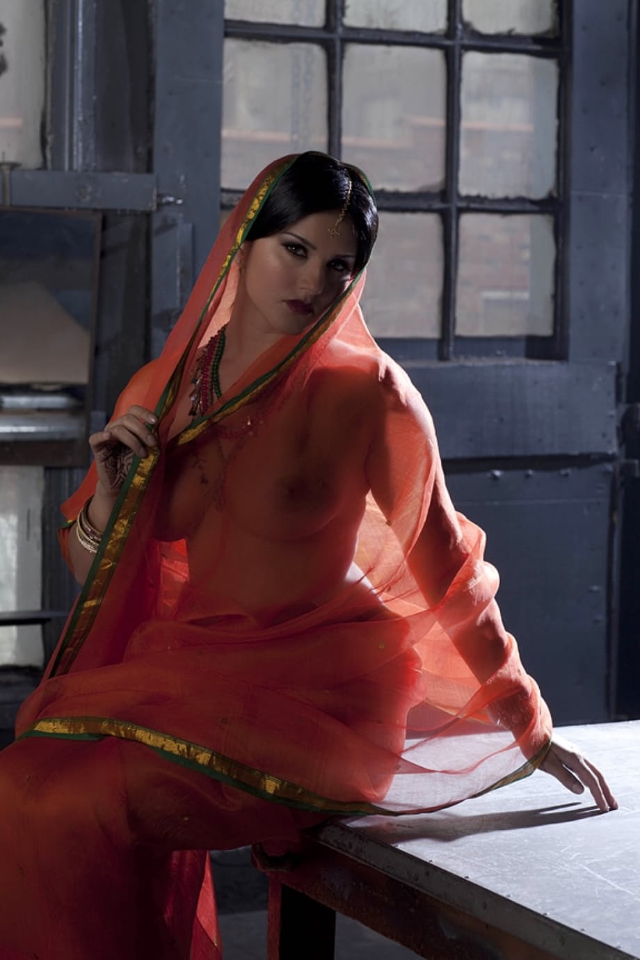 Busty solo girl Sunny Leone models solo in see thru Indian attire