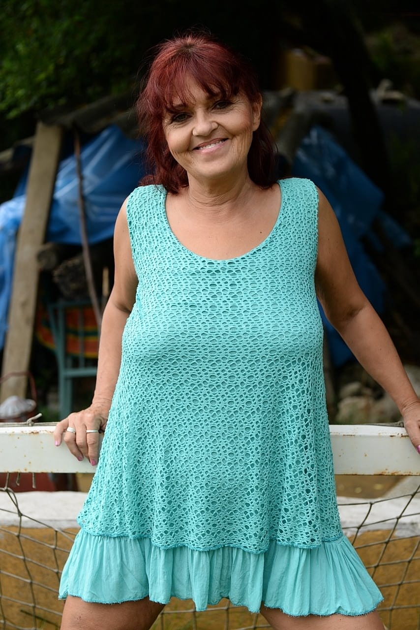 Redhead granny Livia lifts her blue dress up and reveals big natural tits