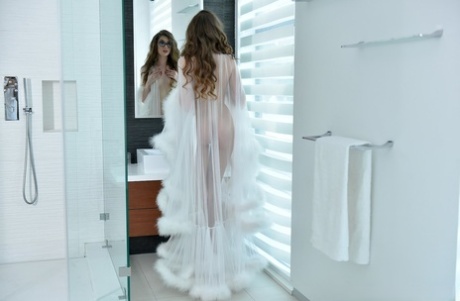 Glasses clad Russian stunner Elena Koshka poses erotically in sheer lingerie