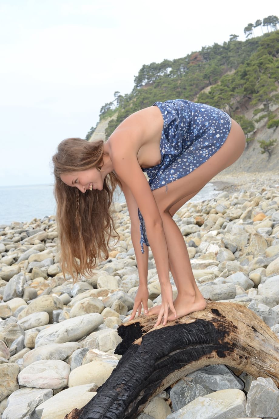 Adorable skinny babe Geisha B exposes hairy pussy on pebble beach