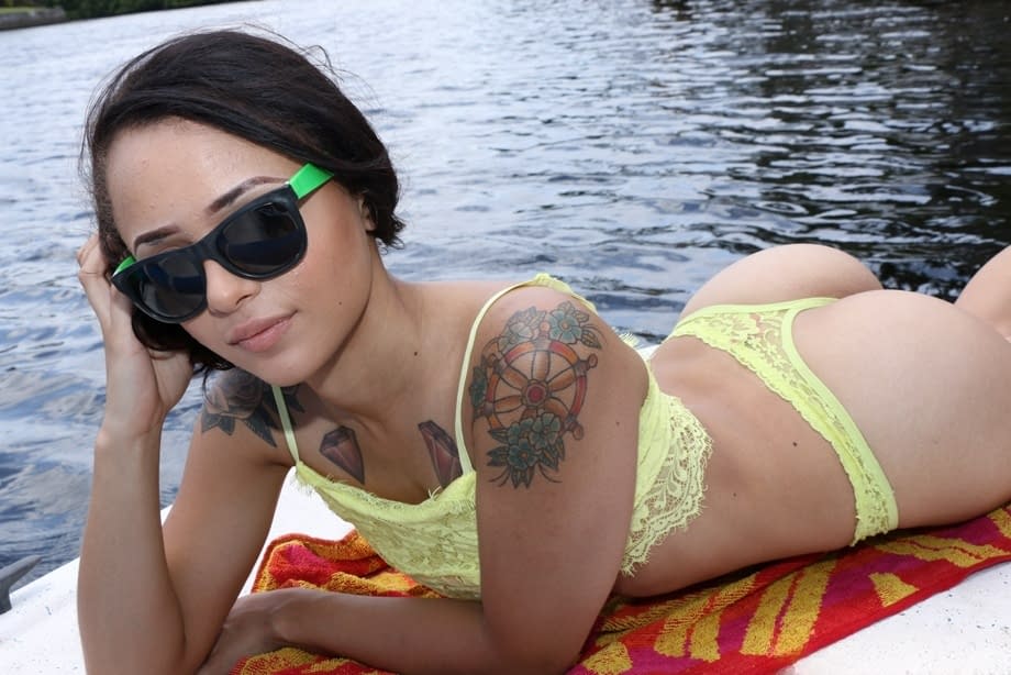 Petite Latina babe Holly Hendrix strips and poses sexily on the boat