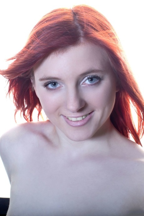 Pale redhead Vanessa Shelby strips on the conference table to spread naked