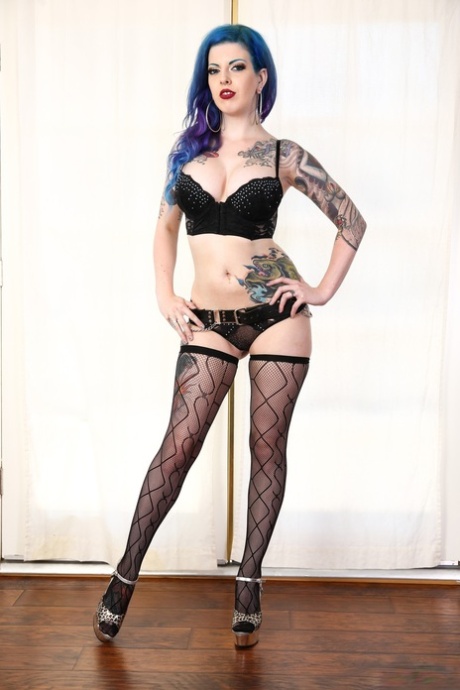 Busty inked Penny Poison performs sexy swordplay naked in black stockings