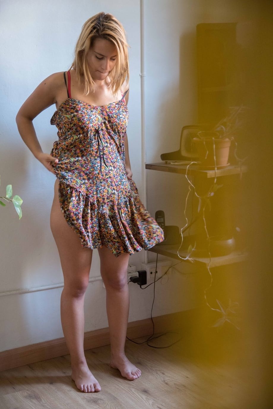 Naked white chick pulls on her bra and panties as she gets dressed