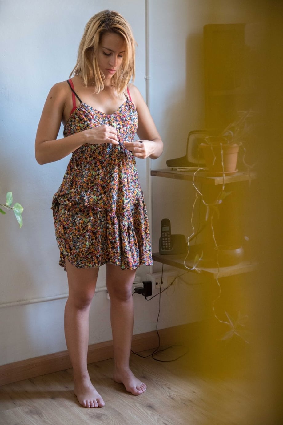 Naked white chick pulls on her bra and panties as she gets dressed