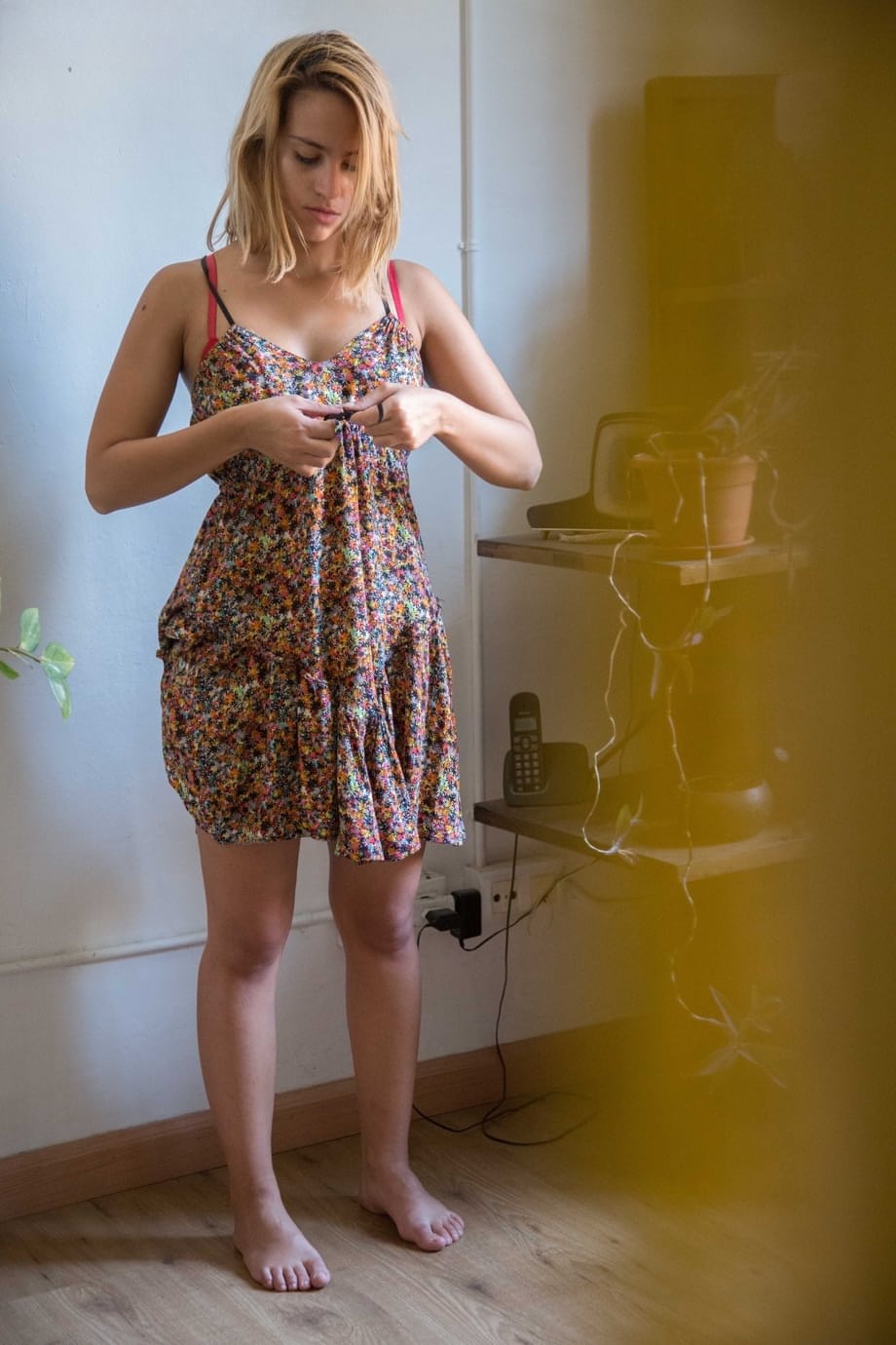 Naked white chick pulls on her bra and panties as she gets dressed