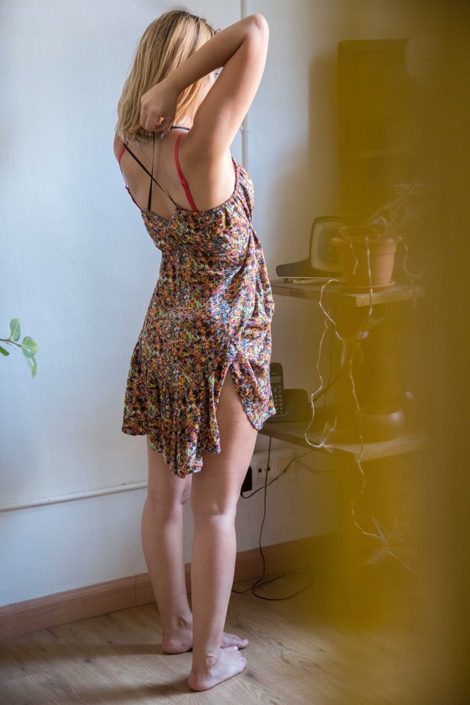 Naked white chick pulls on her bra and panties as she gets dressed