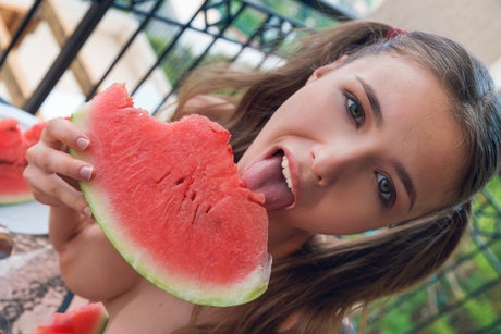 Big titted teen Mila Azul masturbates while eating watermelon on the balcony