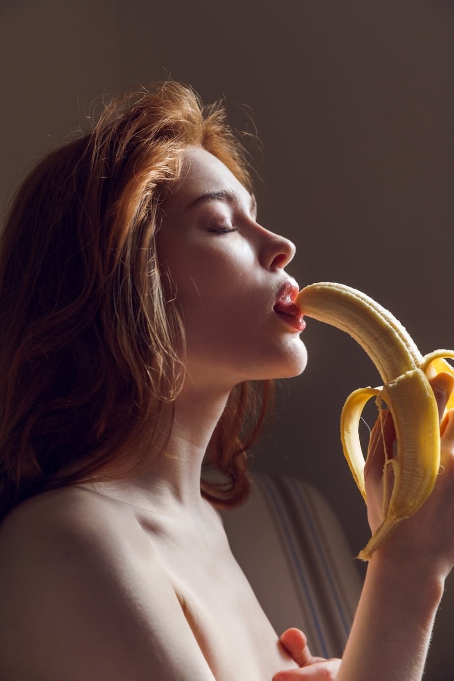 Pale redhead Jia Lissa fingers her teen pussy after eating a banana
