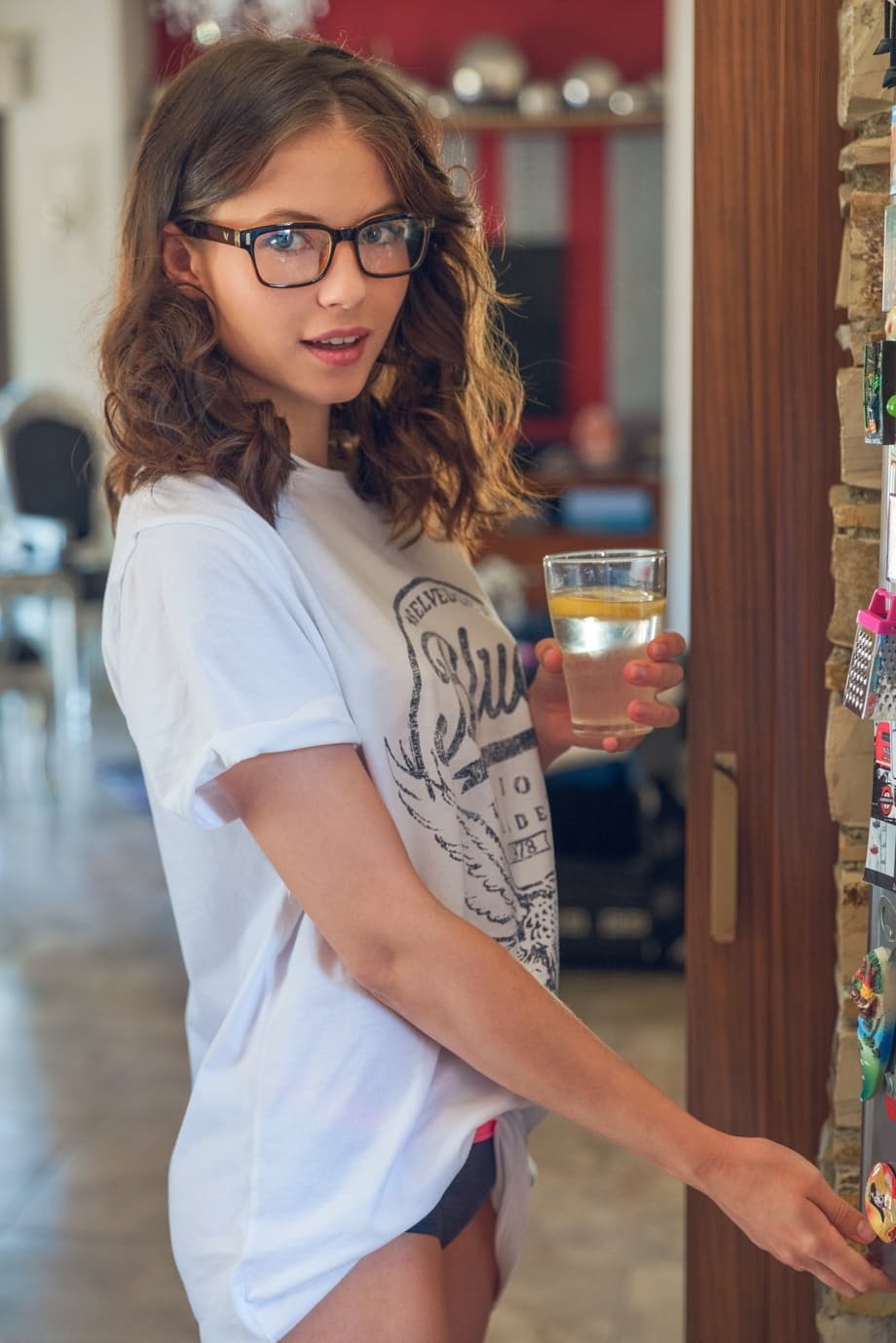 Teen with glasses Hilary gets nude in the kitchen to enjoy her lemon water