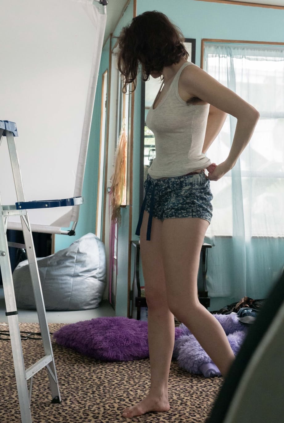 Slender Charlee shows nice tits and thick underarm hair while getting dressed