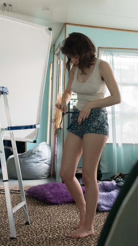 Slender Charlee shows nice tits and thick underarm hair while getting dressed