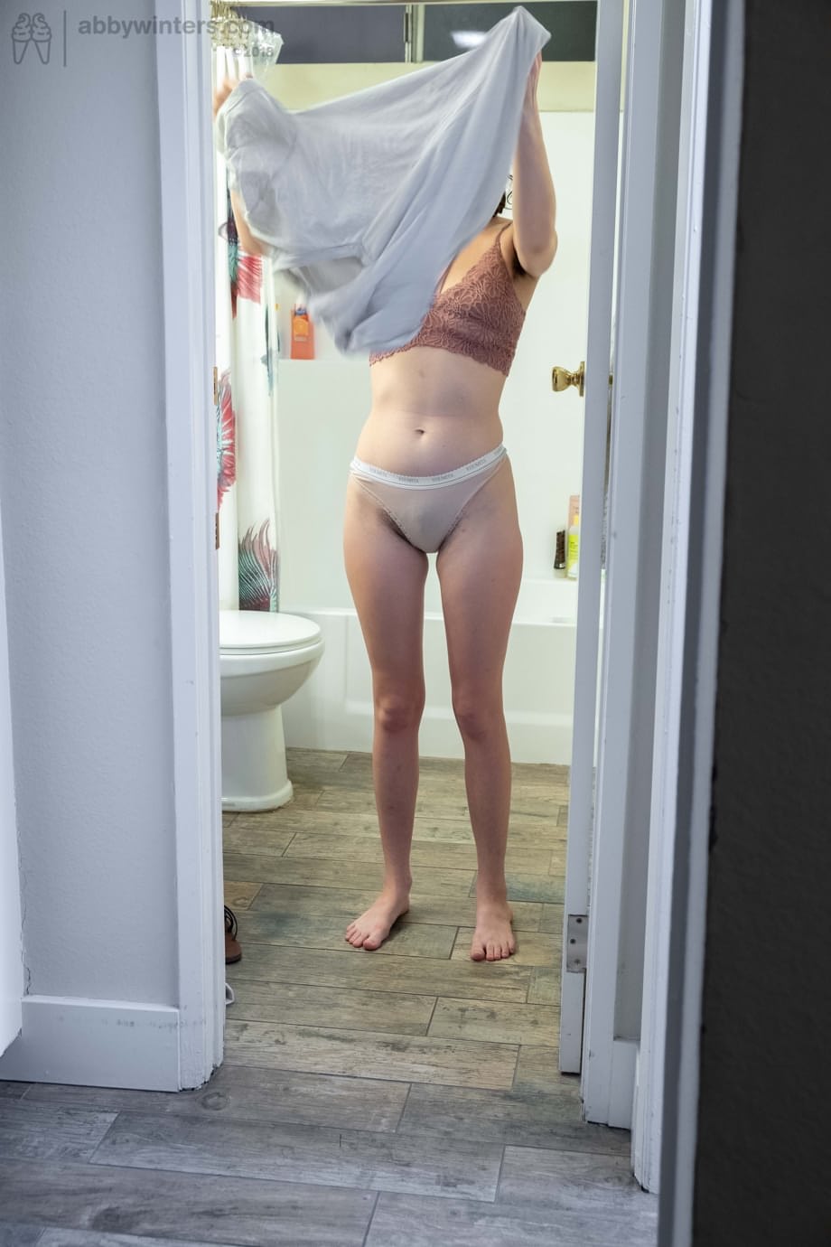 Naked brunette with natural bush Mary J caught getting dressed in the bathroom