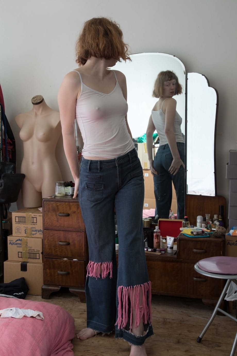 Leggy female with an all natural pussy gets dressed afore her bedroom mirror
