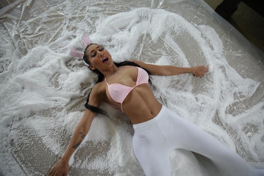 Pigtailed bunny Amia Miley bares big fake tits to play naked in fake snow