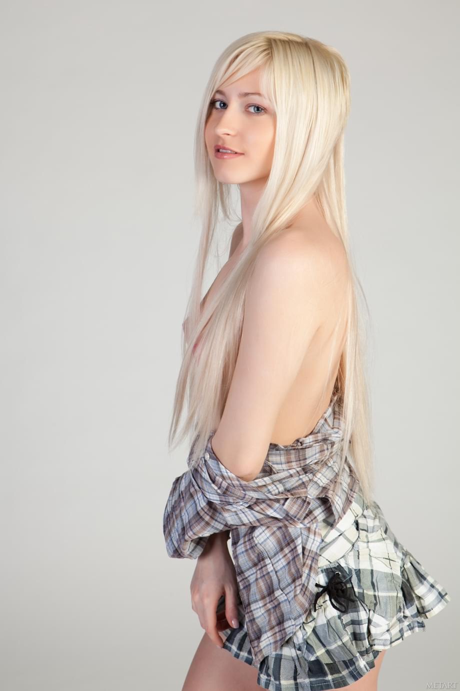 Sweet blonde teen Janelle B teasingly exposes her smooth vagina