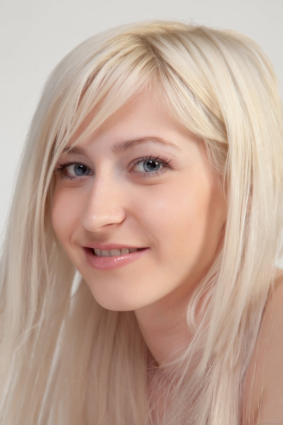 Sweet blonde teen Janelle B teasingly exposes her smooth vagina