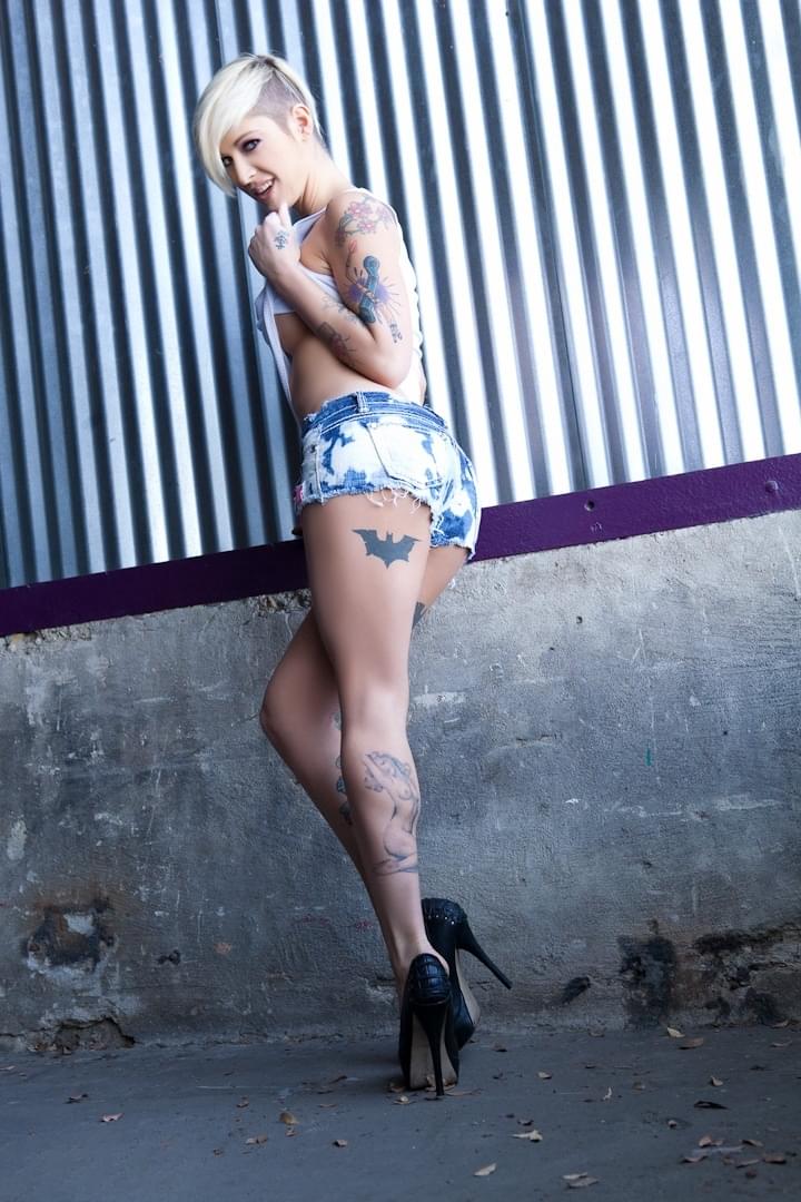 Alluring blonde babe with short hair and slender body showing off in solo act