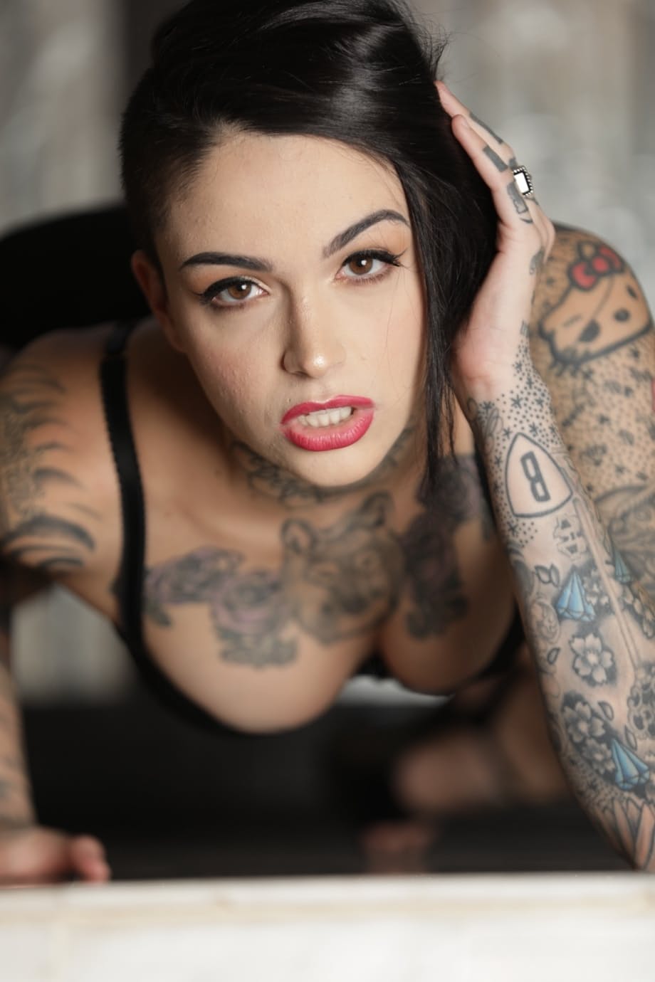 Tattooed alt model Leigh Raven peels off her bra and shorts to pose nude