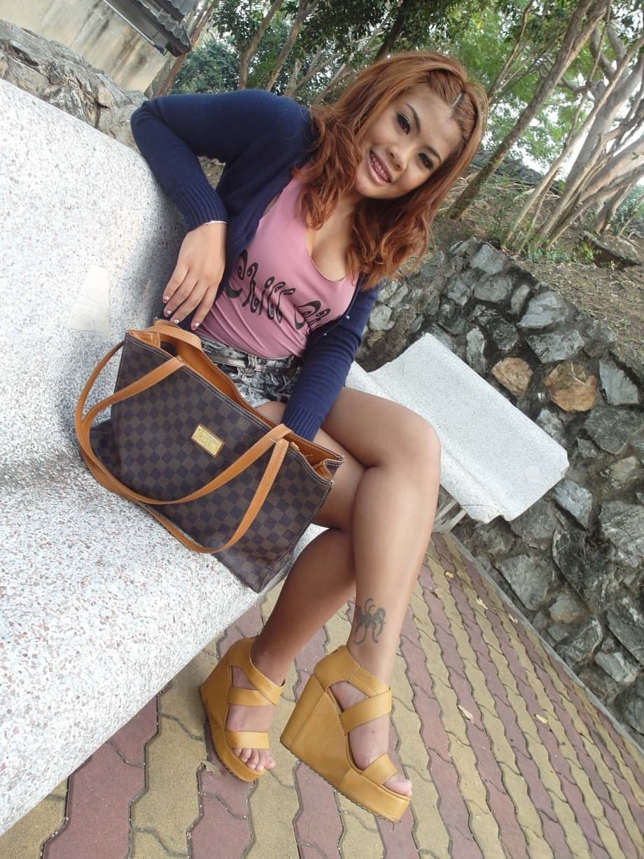 Smiling hooker from Asia exposes big boobs and groomed pussy solo
