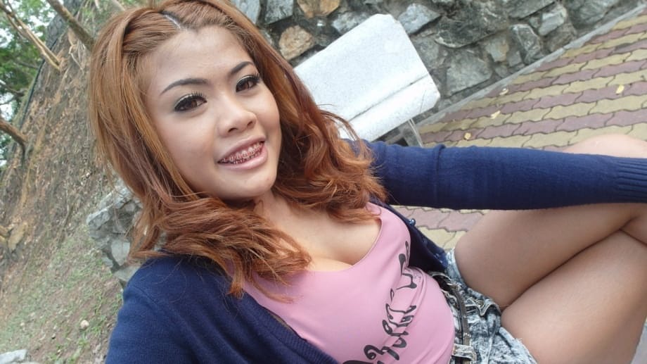 Smiling hooker from Asia exposes big boobs and groomed pussy solo