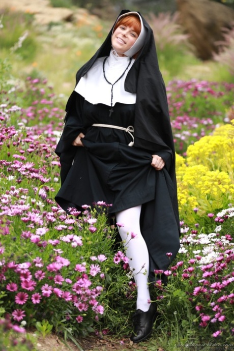 Redheaded nun Penny Pax shows off her big natural boobs and twat
