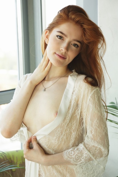 Pale redhead Jia Lissa spreads her legs and pussy after getting naked