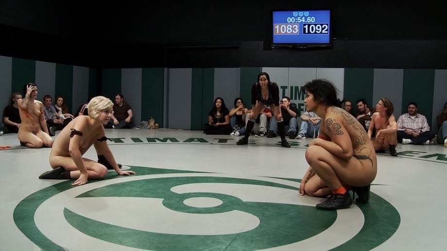 Wrestlers give up a bout to begin being masturbated by a referee