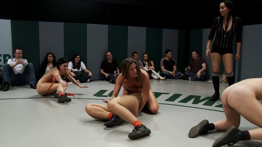 Wrestlers give up a bout to begin being masturbated by a referee