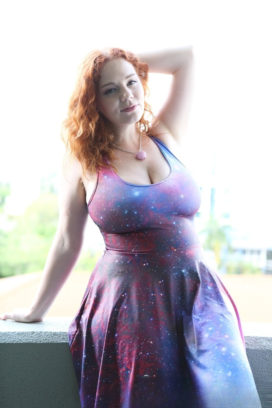Chubby solo girl with curly red hair displays her incredible breasts