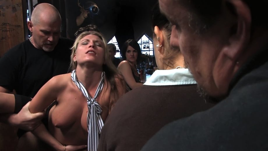 Cute sexy blonde is masturbated while being gangbanged in a bar