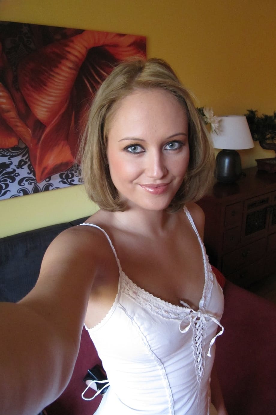 Middle-aged beauty removes her lingerie to set her perky boobs free