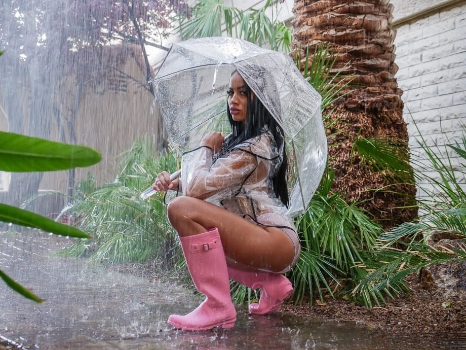 Ebony bombshell Victoria June bares enhanced big tits to fuck in rubber boots