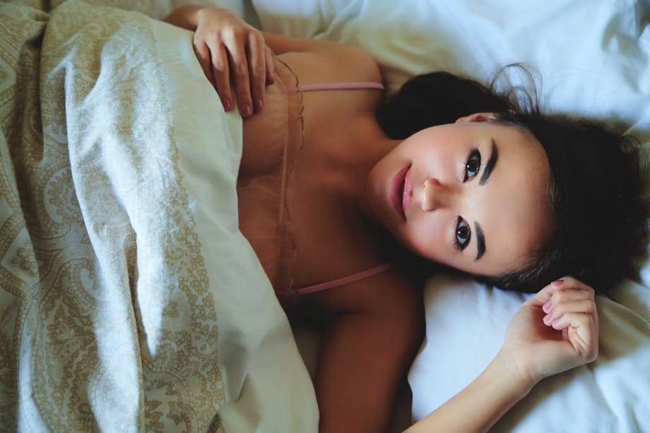 Sultry solo girl Li Moon displays her perfect pussy while reading a book