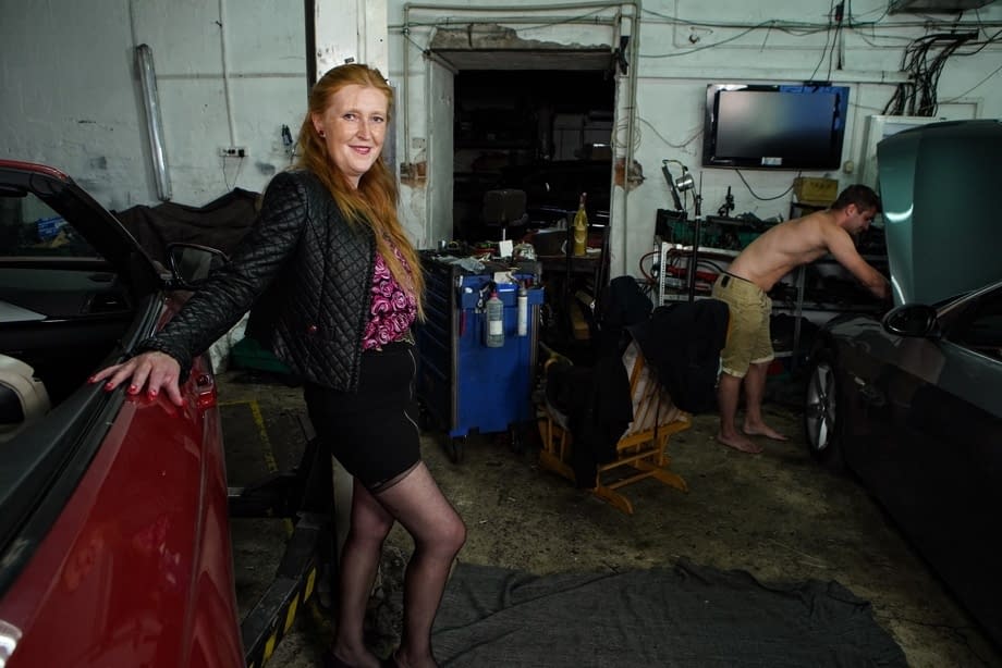 Redheaded amateur has sex with a younger man while in a garage