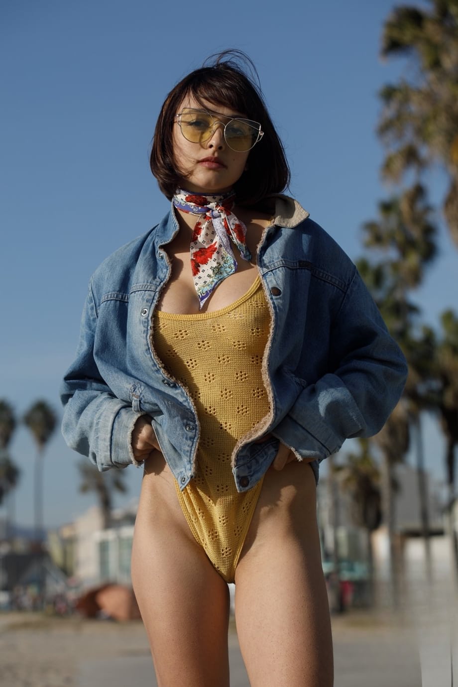 Adorable teen Basil Navas poses on the beach in yellow see-through bodysuit