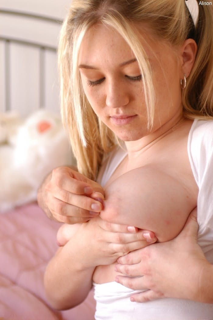 Busty blonde Alison Angel fondles her big natural tits on a bed