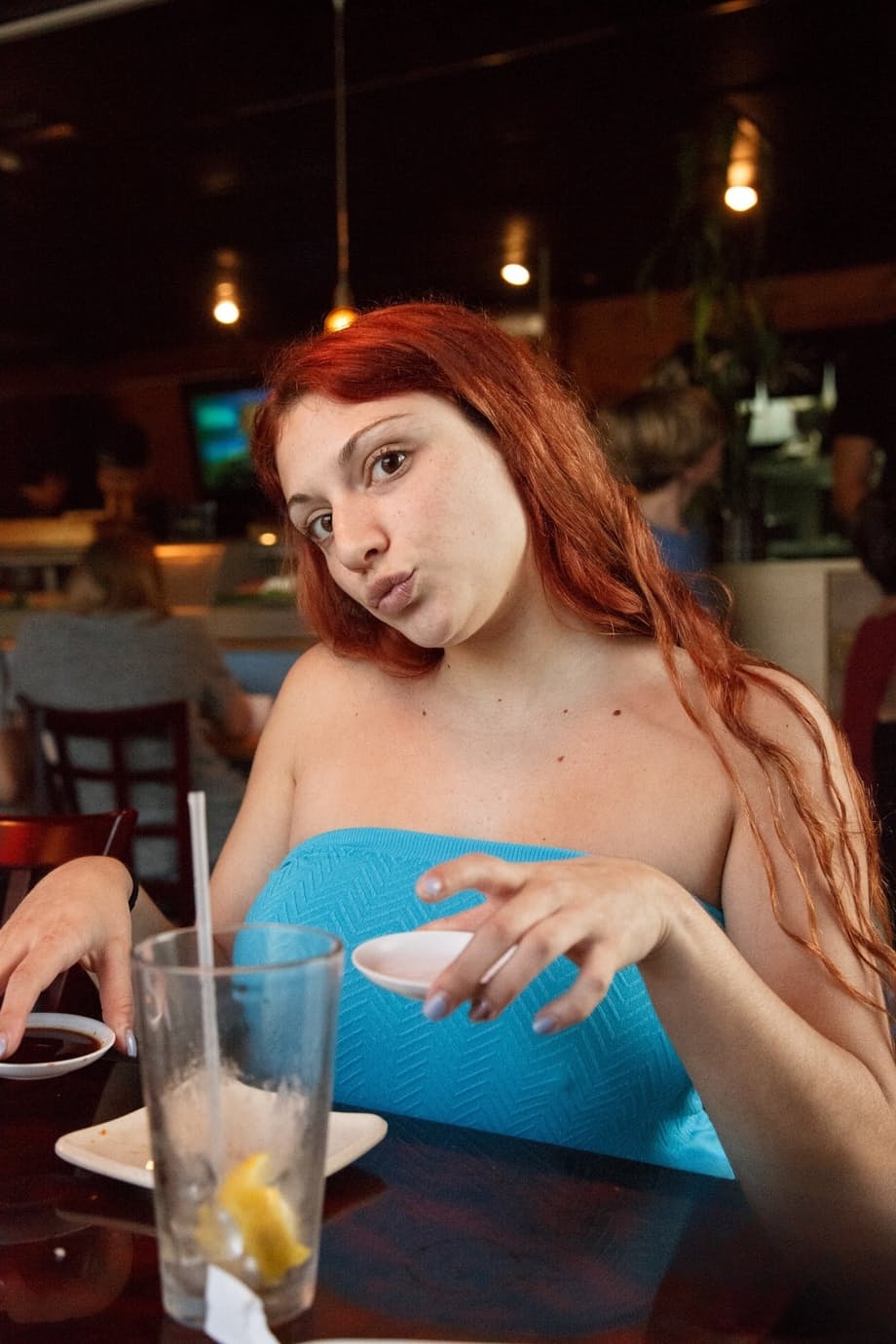 Curvaceous redhead Gina Rosini flashes her big tits, round ass and hairy twat