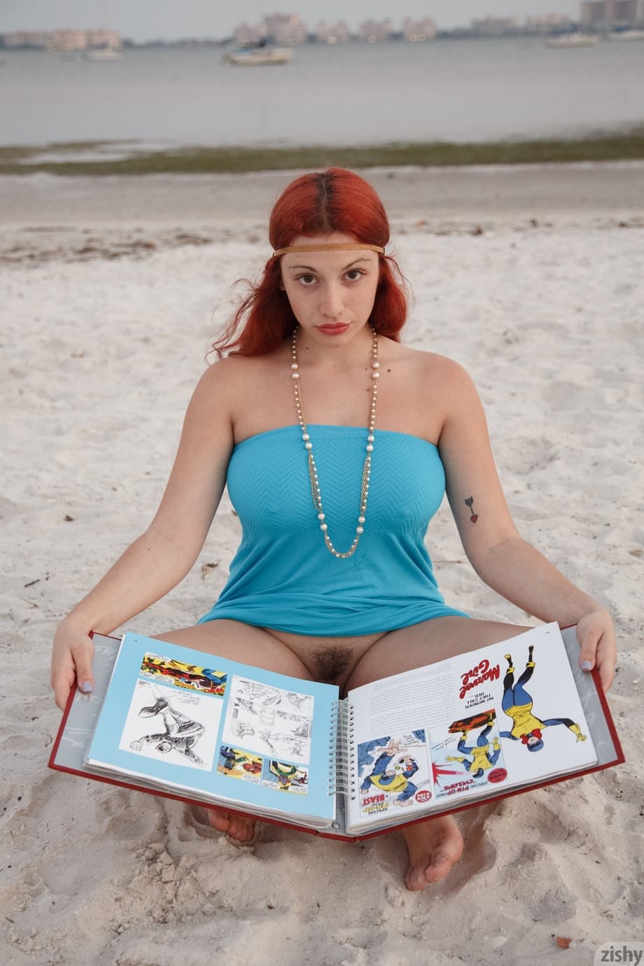 Curvaceous redhead Gina Rosini flashes her big tits, round ass and hairy twat