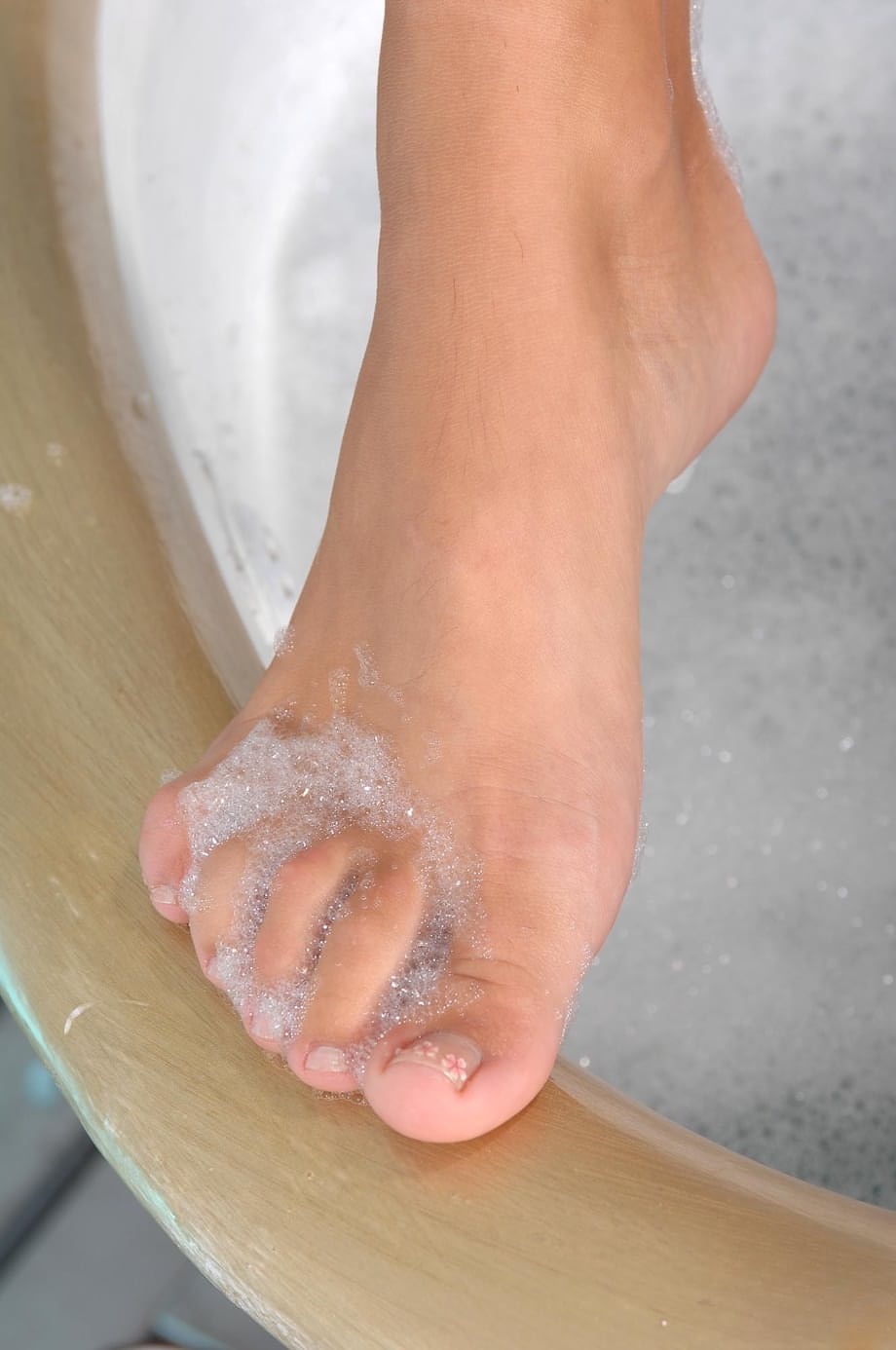 Babes Candy and Sasha Rose strip and enjoy foot fetish sex in a bathtub