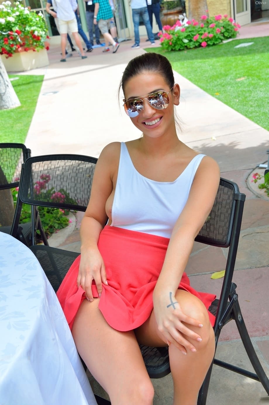 Braless beauty Olivia flashes her boobs and hot panties in a crowded place