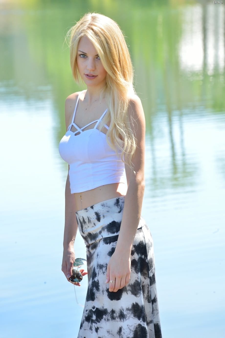 Blonde teen Blake Eden gets naked in flip-flops outside a building