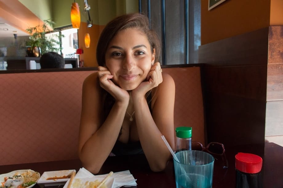 Cute Latina teen Nina North gets totally naked on a bed after eating out