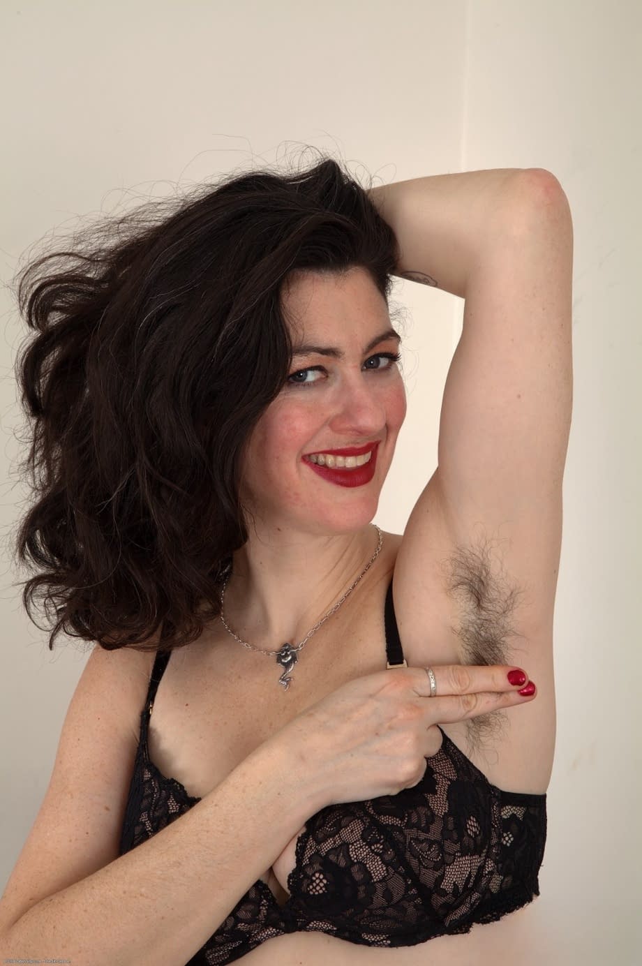 Pretty brunette Sadie Lune puts her trimmed bush on display upon a table