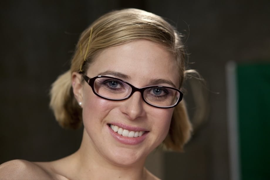 Nerdy pornstar Penny Pax shows her natural tits and poses in sheer pantyhose