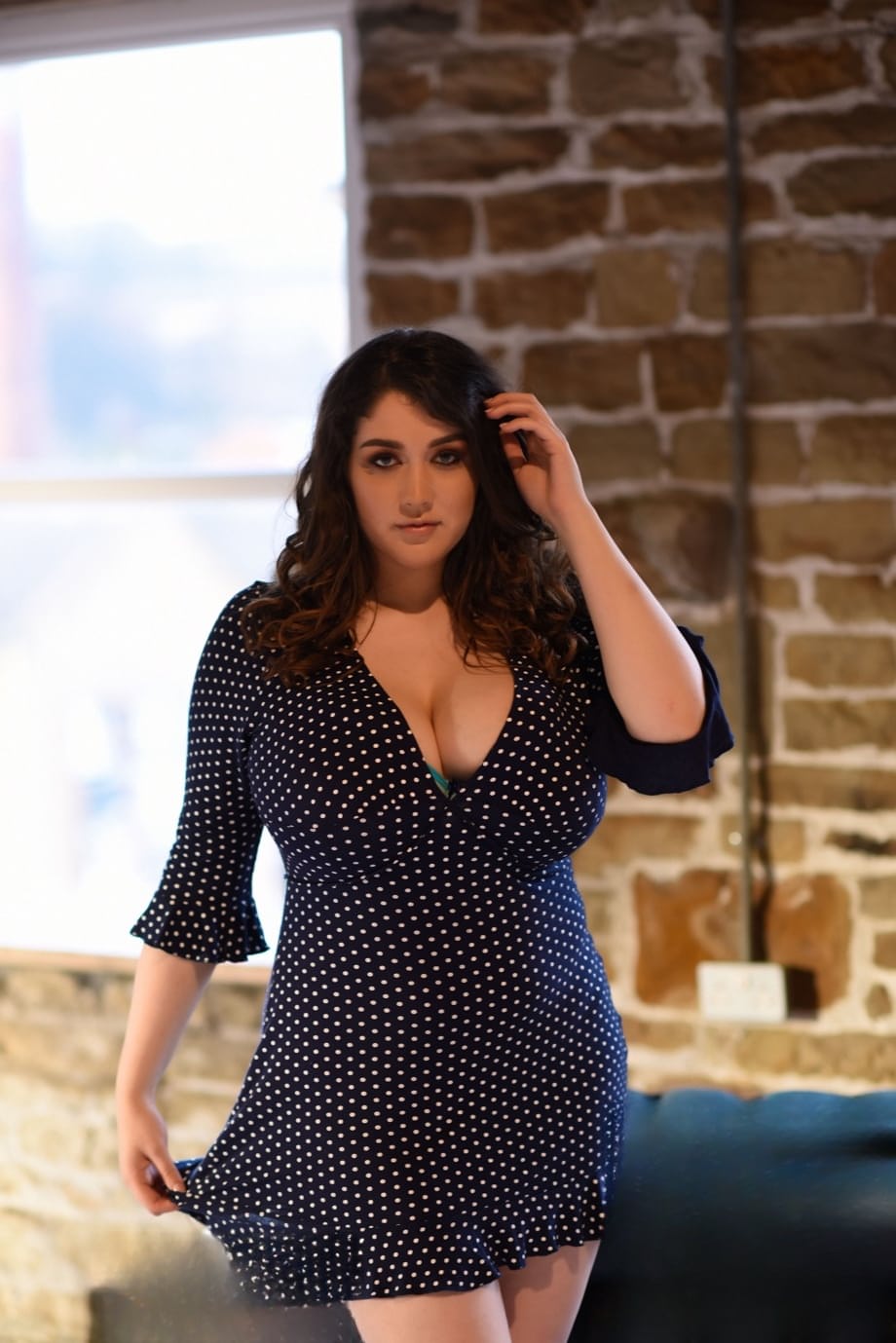 Thick brunette Bella B reveals her large melons and poses topless