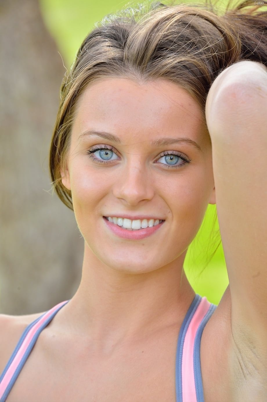 Petite blue-eyed brunette Lana strikes sexy nude poses outdoors