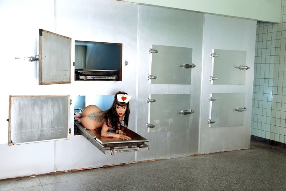Naughty nurse Masuimi Max strips to show big tits & her hot body in a morgue