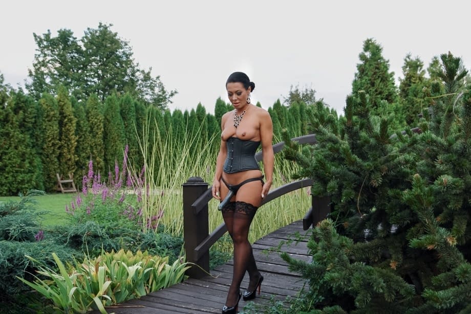 Romanian femdom Sandra Romain slaps and fucks her slave's ass on the bridge
